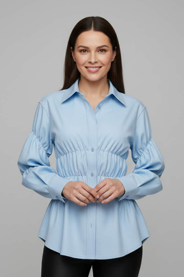 Women’s blouse with front buttons and gathered waist detail, featuring long sleeves and a flared hem for everyday and workwear styling.