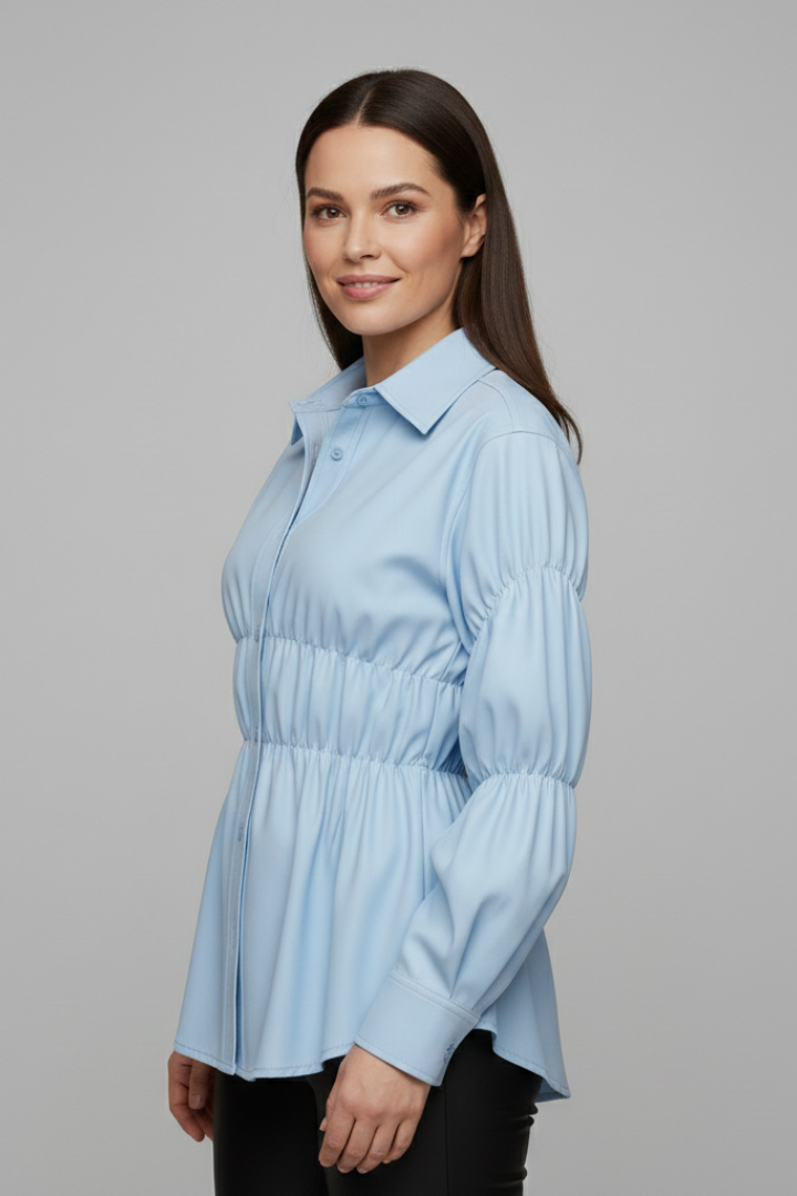 Women’s blouse with front buttons and gathered waist detail, featuring long sleeves and a flared hem for everyday and workwear styling.