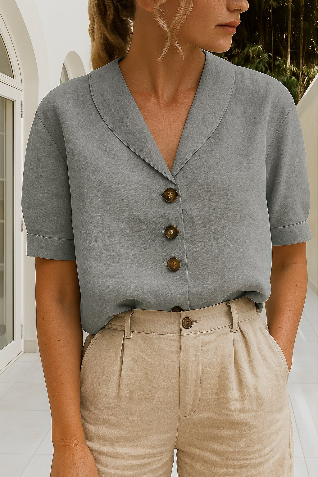 Women’s blouse with V-neckline, button-front closure, short sleeves, and relaxed fit, suitable for office wear and everyday styling.