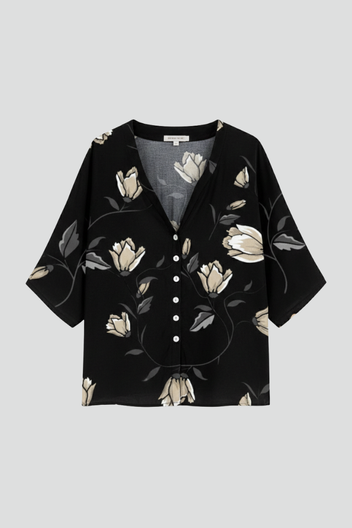 Women’s blouse with V-neckline and front button detailing, featuring short sleeves and floral print for everyday and casual styling.