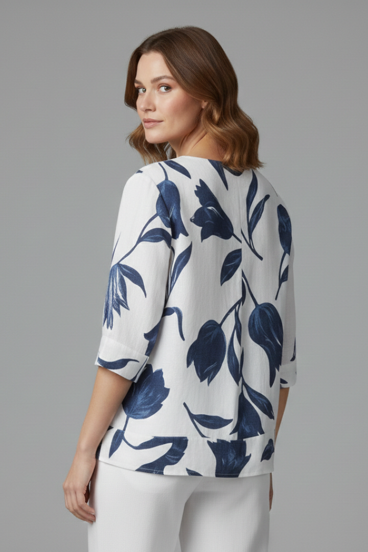 Women’s blouse with V-neckline and large floral print, featuring three-quarter sleeves and button placket for everyday and work styling.
