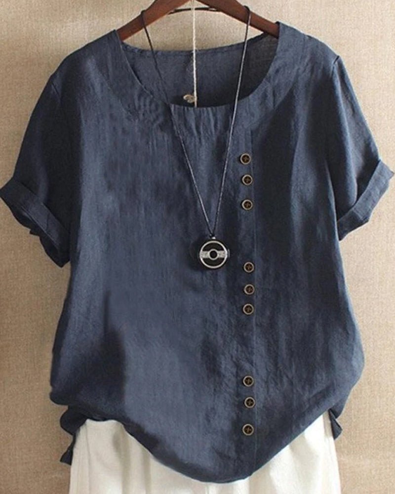Women’s blouse with decorative button details, short sleeves, and a relaxed fit, ideal for casual summer outfits, travel, and everyday wear.