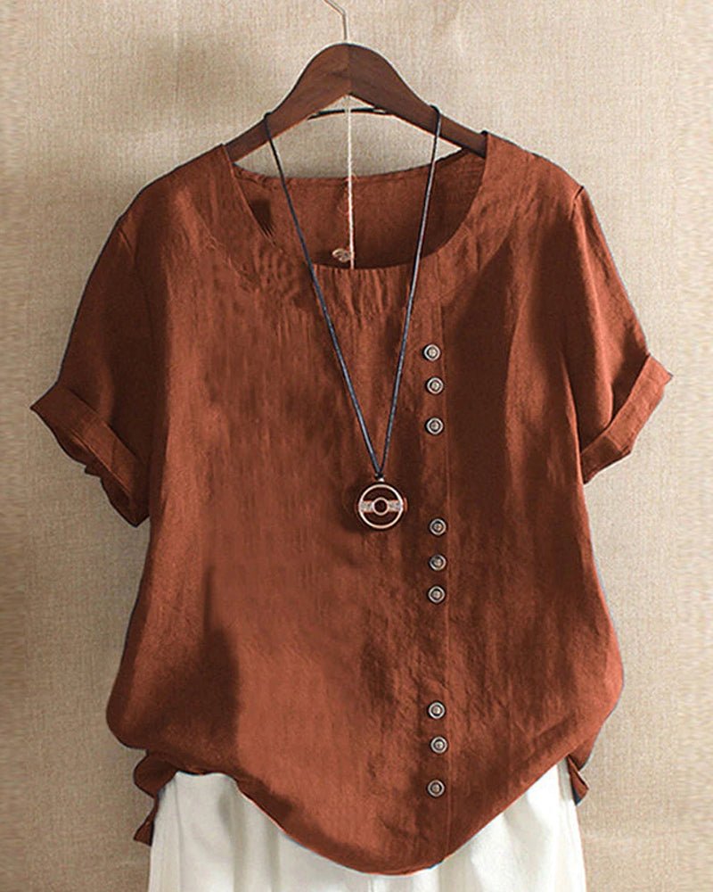 Women’s blouse with decorative button details, short sleeves, and a relaxed fit, ideal for casual summer outfits, travel, and everyday wear.