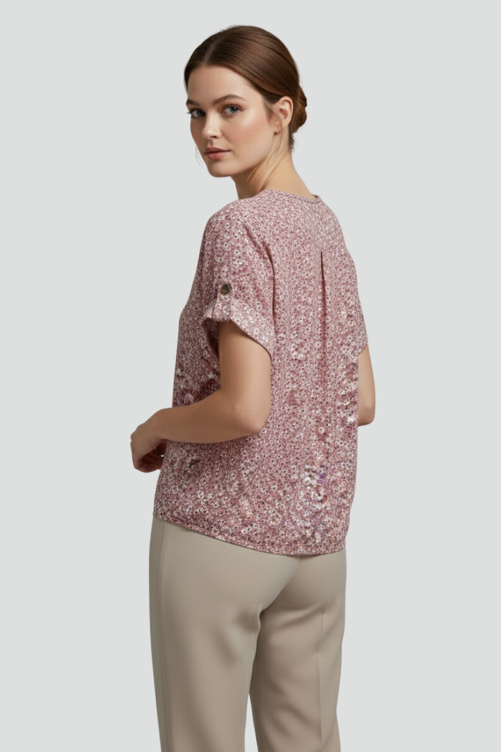 Women’s short sleeve blouse with round neckline, button front, printed surface, and straight hem for casual everyday styling.