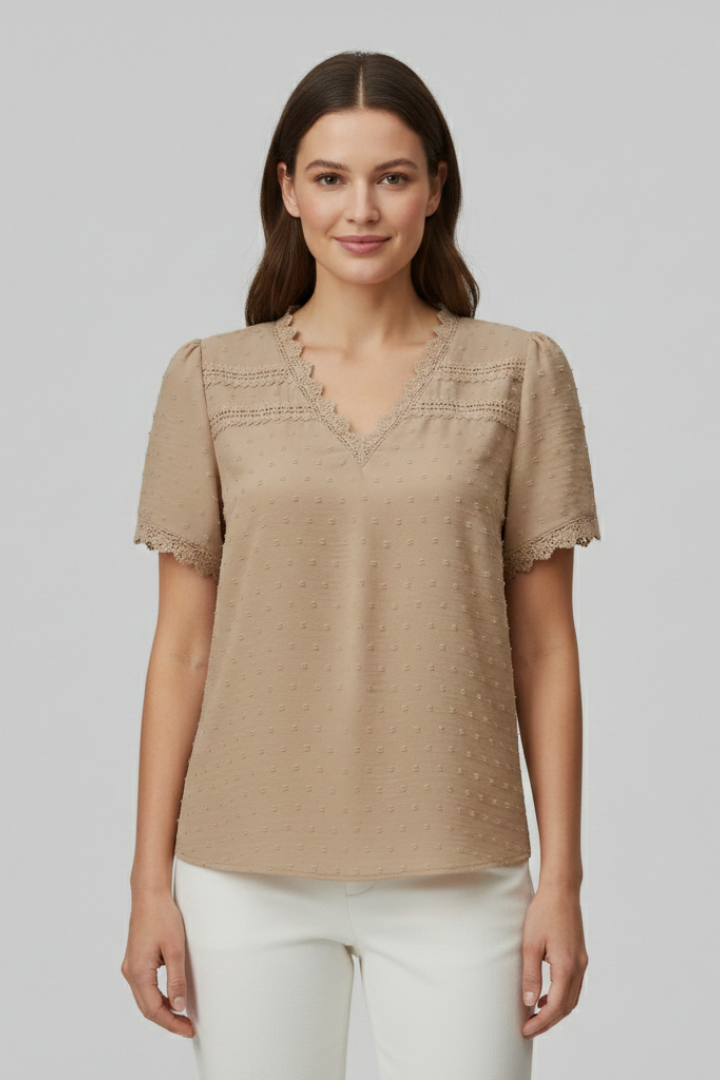 Women’s short sleeve blouse with V neckline, partial button fastening, and textured semi-sheer surface, suitable for office wear and everyday styling.