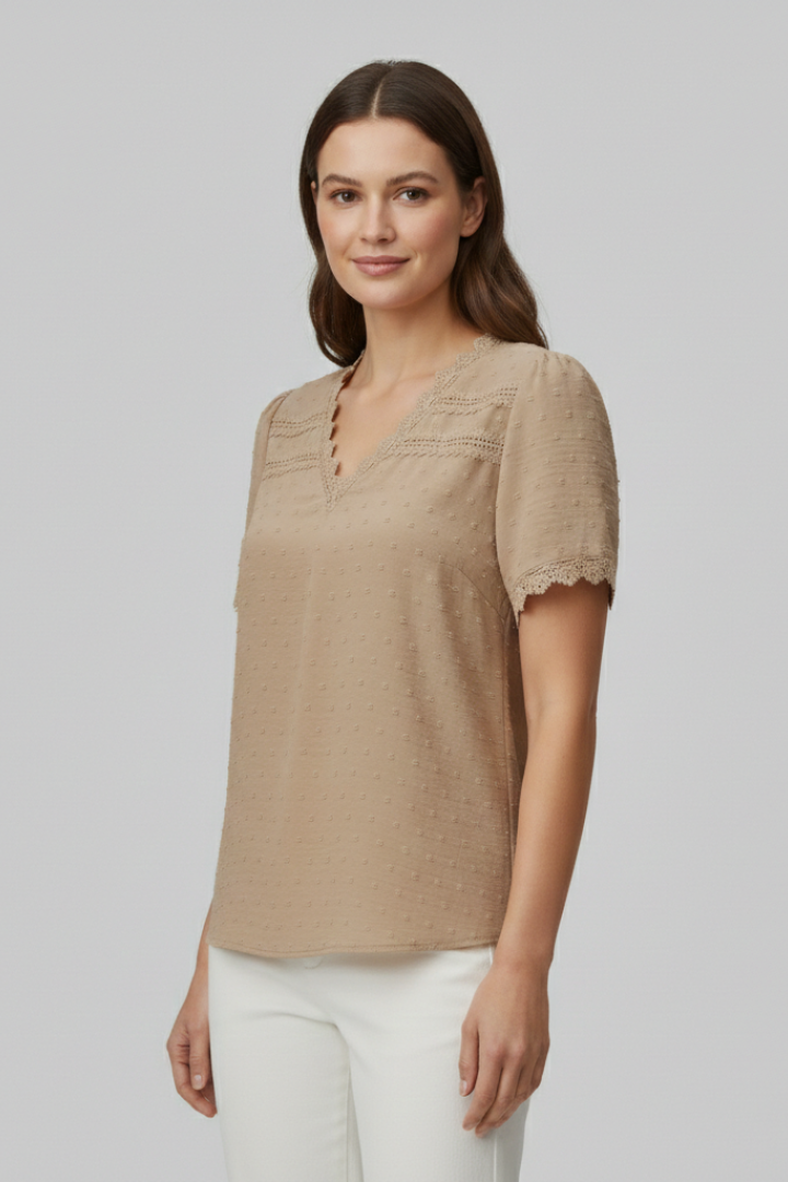 Women’s short sleeve blouse with V neckline, partial button fastening, and textured semi-sheer surface, suitable for office wear and everyday styling.