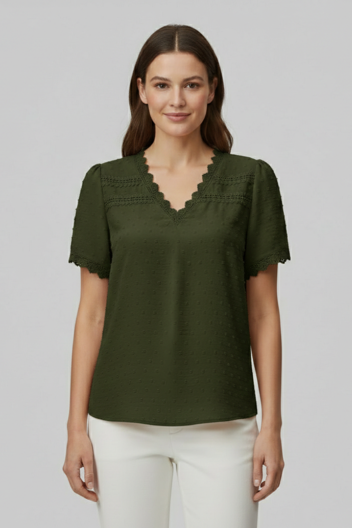 Women’s short sleeve blouse with V neckline, partial button fastening, and textured semi-sheer surface, suitable for office wear and everyday styling.