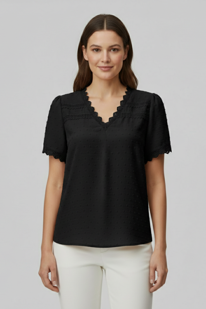Women’s short sleeve blouse with V neckline, partial button fastening, and textured semi-sheer surface, suitable for office wear and everyday styling.