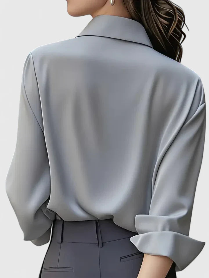 Women’s button front top with a collared neckline, curved hem, and relaxed fit, ideal for office wear and smart-casual outfits.