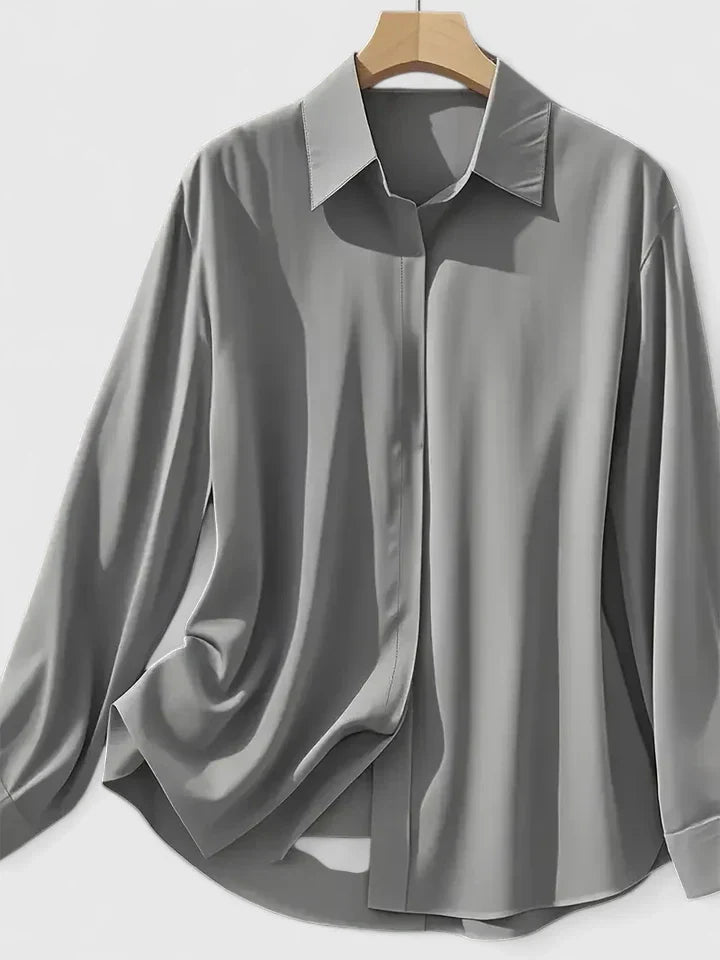 Women’s button front top with a collared neckline, curved hem, and relaxed fit, ideal for office wear and smart-casual outfits.