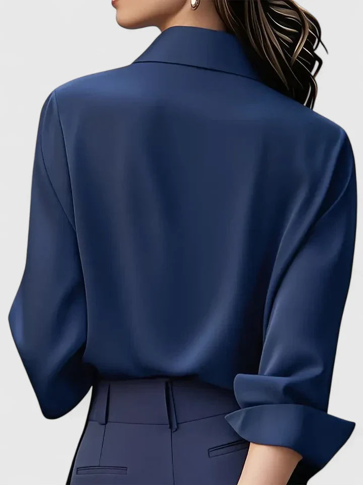 Women’s button front top with a collared neckline, curved hem, and relaxed fit, ideal for office wear and smart-casual outfits.
