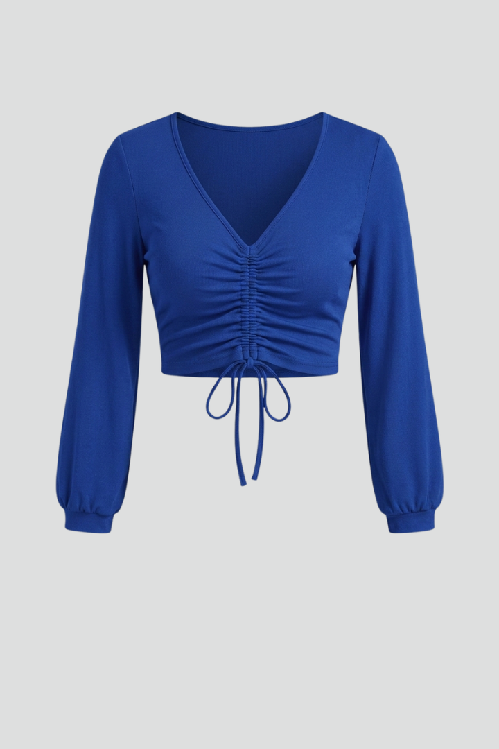 Women’s crop top with ruched front detail, v-neck, and long sleeves, ideal for casual evening outfits and party styling.