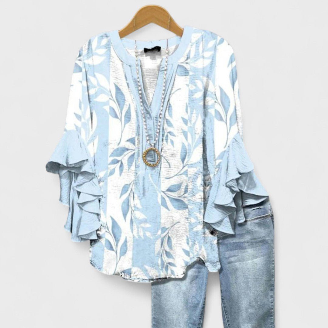 Women’s floral blouse with ruffle sleeves, V-neckline, and relaxed fit, suitable for office wear, casual outings, and everyday styling.
