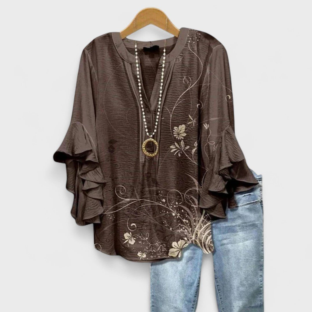 Women’s floral blouse with ruffle sleeves, V-neckline, and relaxed fit, suitable for office wear, casual outings, and everyday styling.