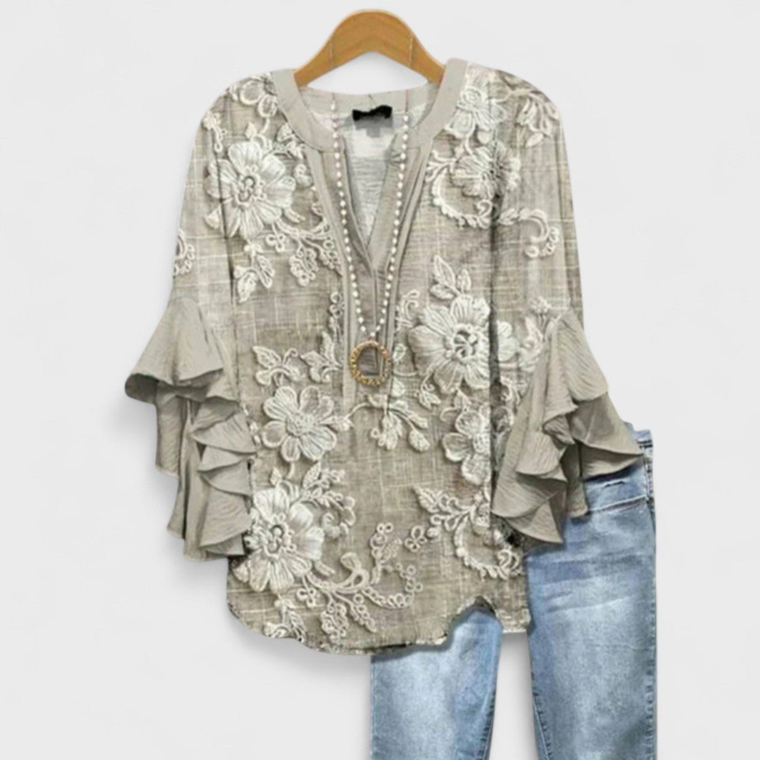 Women’s floral blouse with ruffle sleeves, V-neckline, and relaxed fit, suitable for office wear, casual outings, and everyday styling.