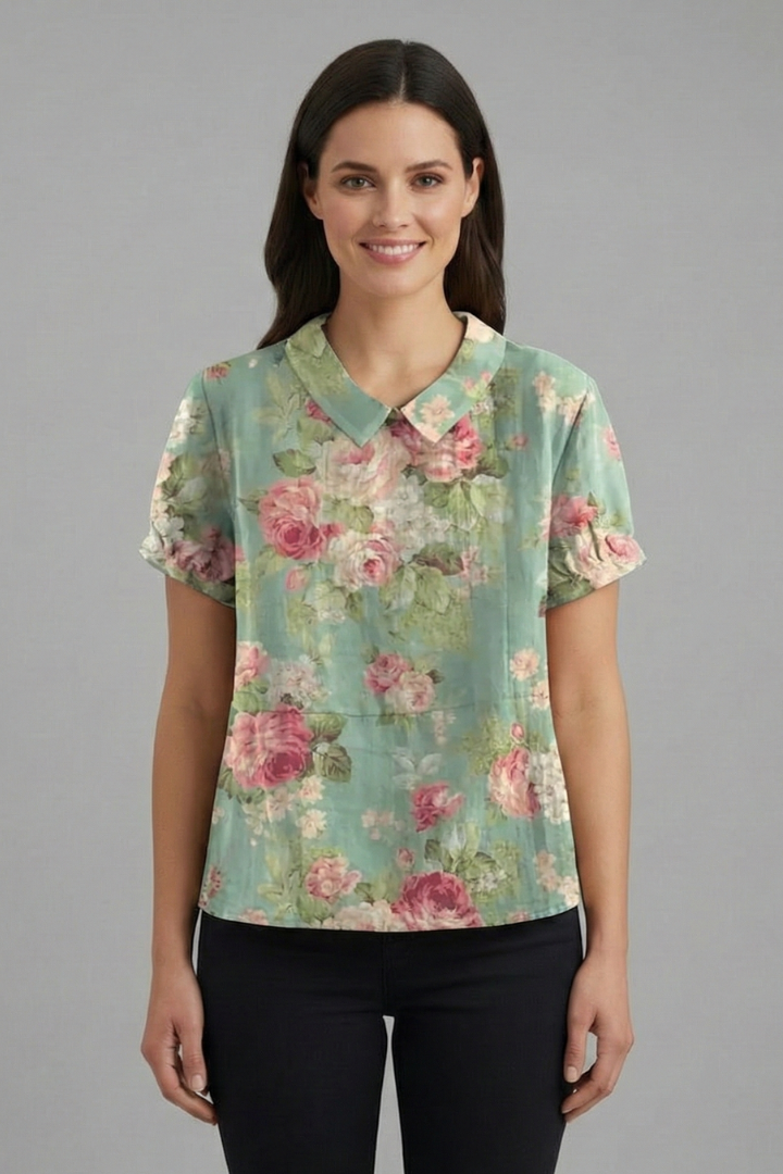 Women’s short sleeve blouse with collared neckline and floral print, featuring a relaxed fit and textured surface for everyday and office wear.
