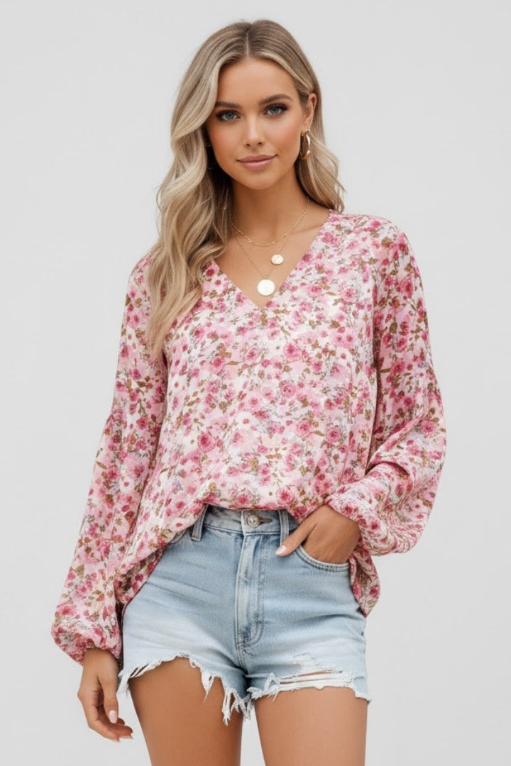 Women’s floral blouse with V-neckline and relaxed fit, featuring long sleeves and all-over print for casual and work outfits
