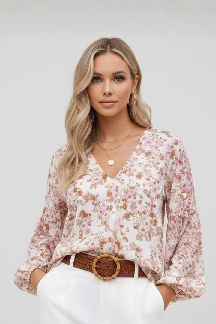 Women’s floral blouse with V-neckline and relaxed fit, featuring long sleeves and all-over print for casual and work outfits