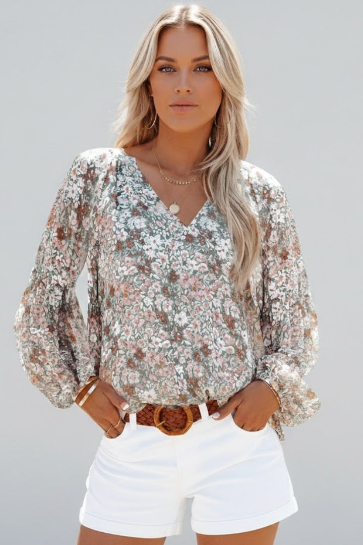 Women’s floral blouse with V-neckline and relaxed fit, featuring long sleeves and all-over print for casual and work outfits