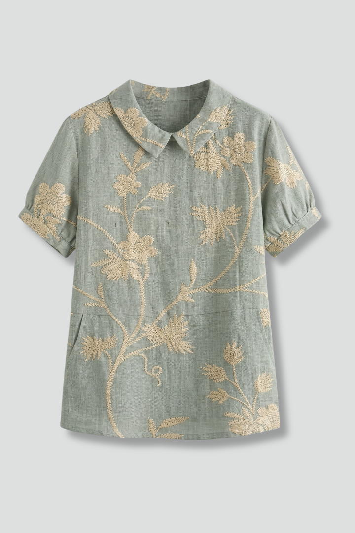 Women’s floral blouse with notch neckline and short sleeves, ideal for casual outfits and smart everyday styling.