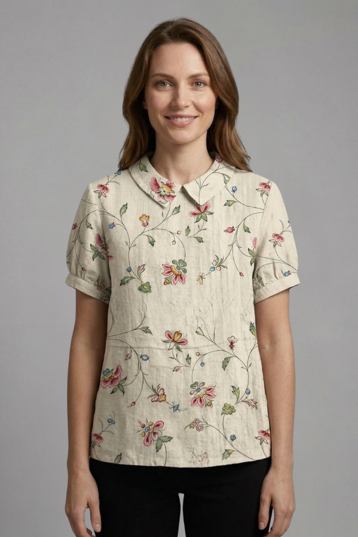 Women’s floral blouse with notch neckline and short sleeves, ideal for casual outfits and smart everyday styling.