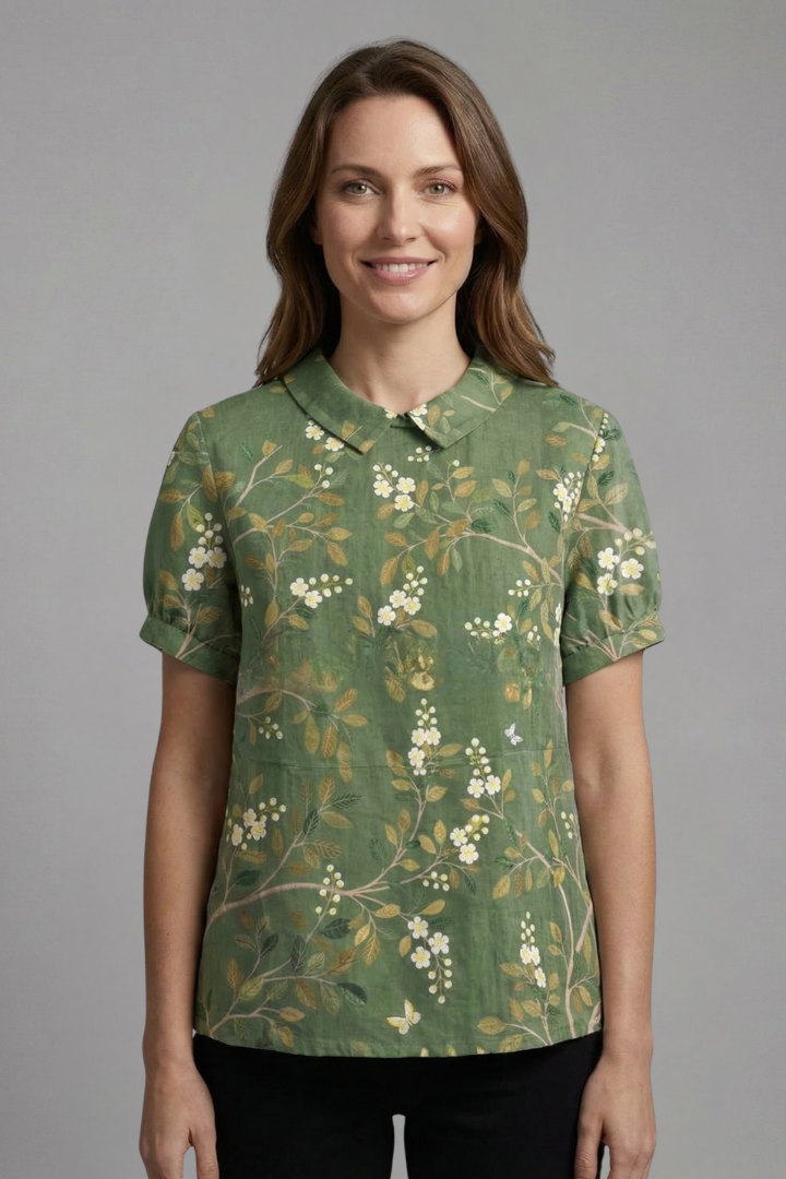 Women’s floral blouse with notch neckline and short sleeves, ideal for casual outfits and smart everyday styling.