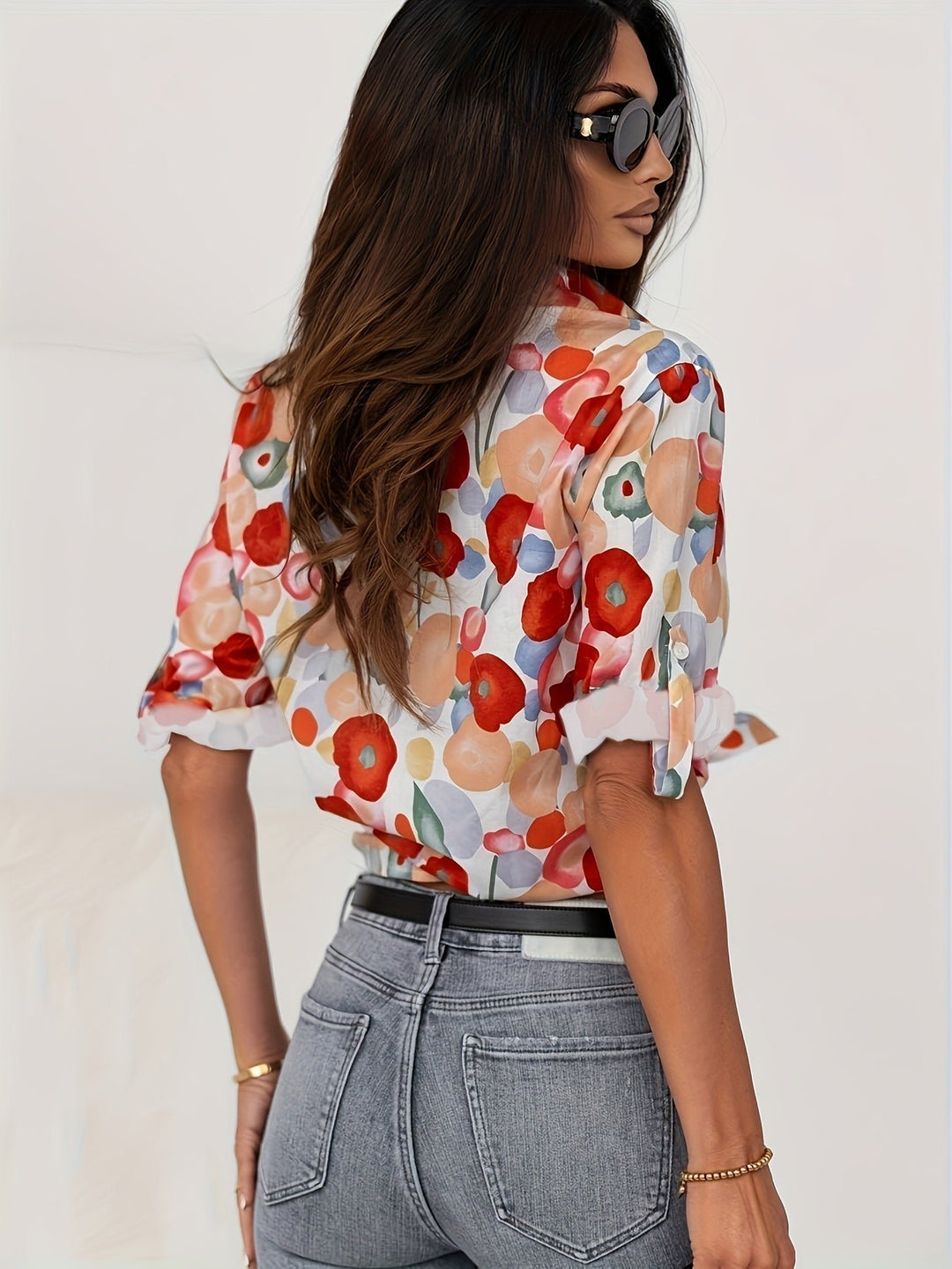 Women’s floral blouse with a button front, watercolor print, and relaxed fit, suitable for casual outfits, office wear, and smart occasions.