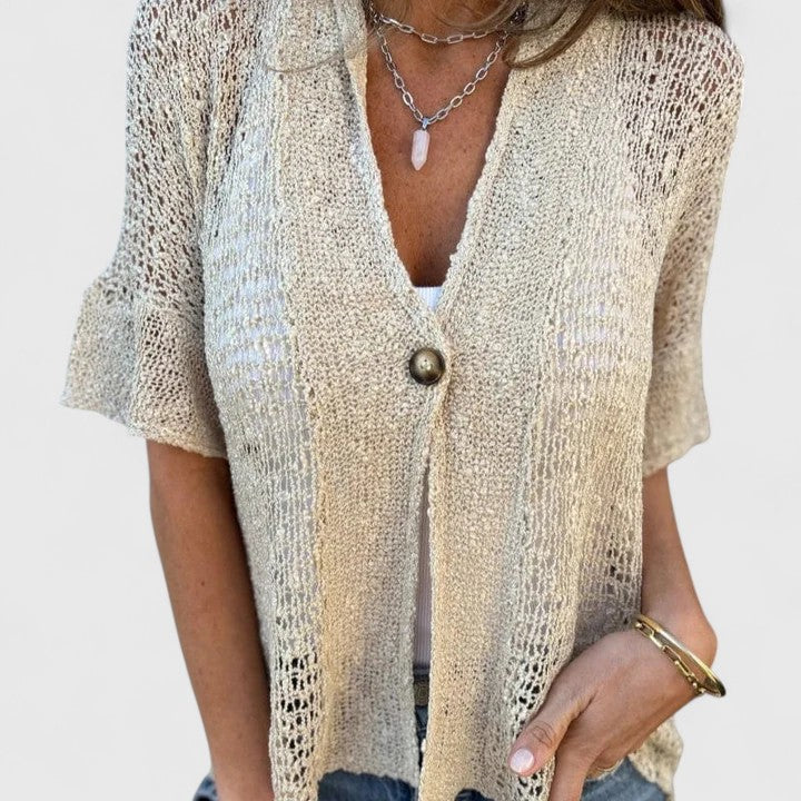 Women’s knit shirt with an open stitch design, single-button closure, and relaxed fit, ideal for warm-weather wear and casual layering.