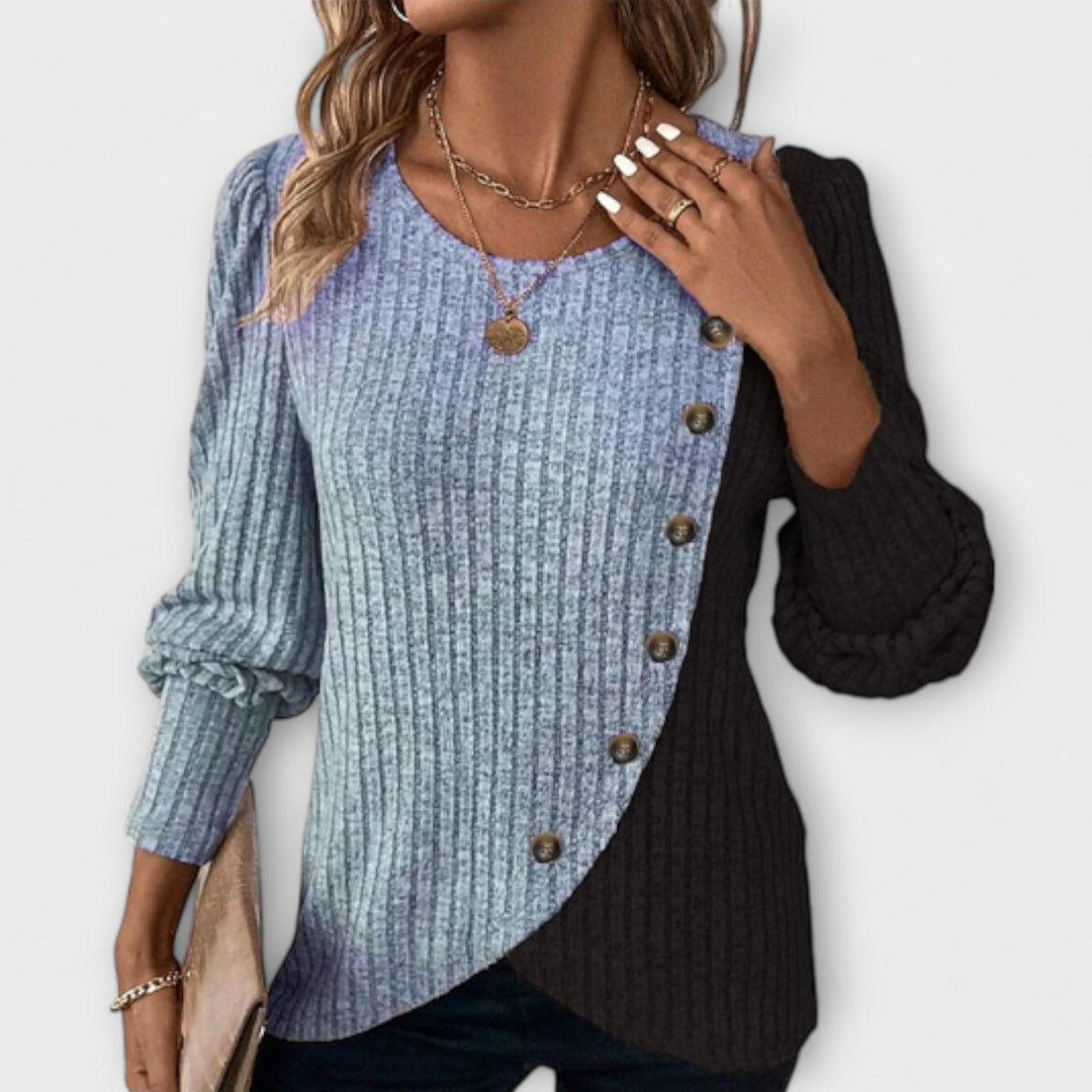 Women’s knitted blouse with colorblock detailing and asymmetric buttons, suitable for office outfits, casual wear, and everyday styling.