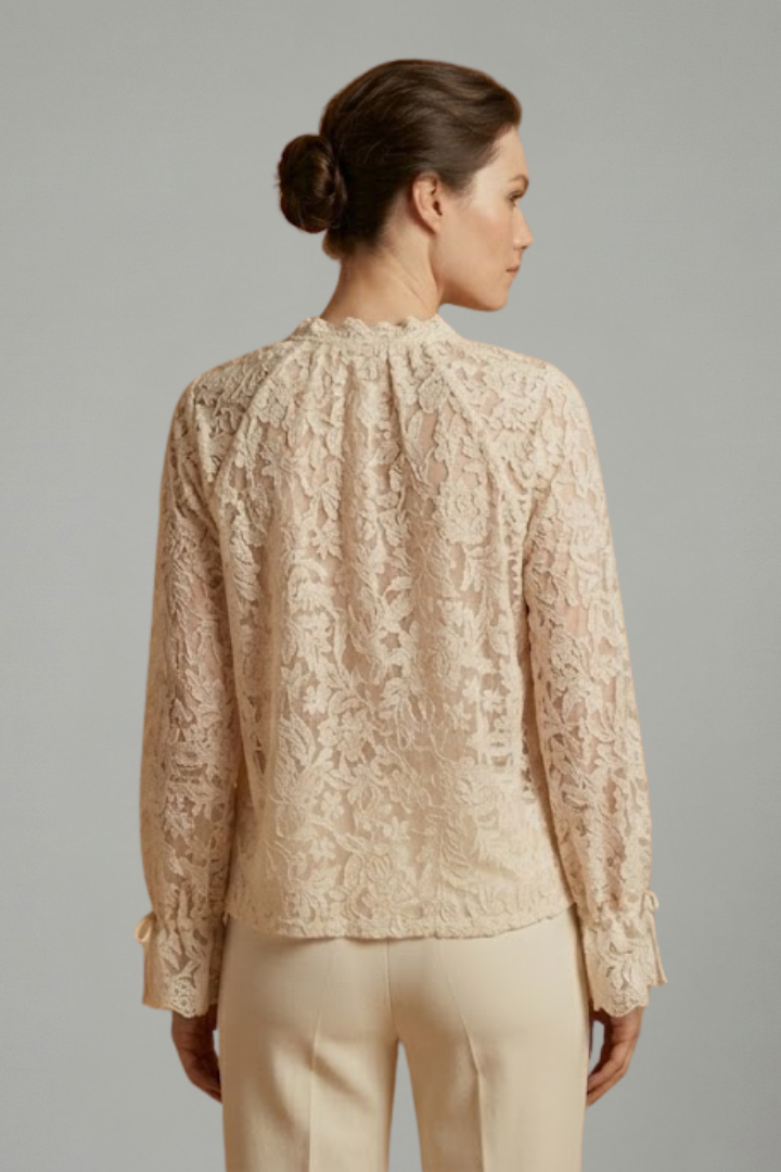 Women’s sheer lace blouse with floral texture, V-neckline button closure, and long flared sleeves for elegant everyday styling.