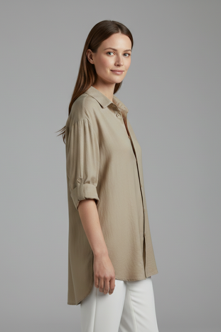 Women’s long blouse with button fastening and chest pockets, featuring a collared neckline and rounded hem for everyday and work styling.