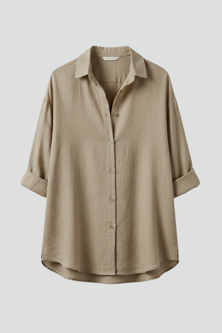 Women’s long blouse with button fastening and chest pockets, featuring a collared neckline and rounded hem for everyday and work styling.