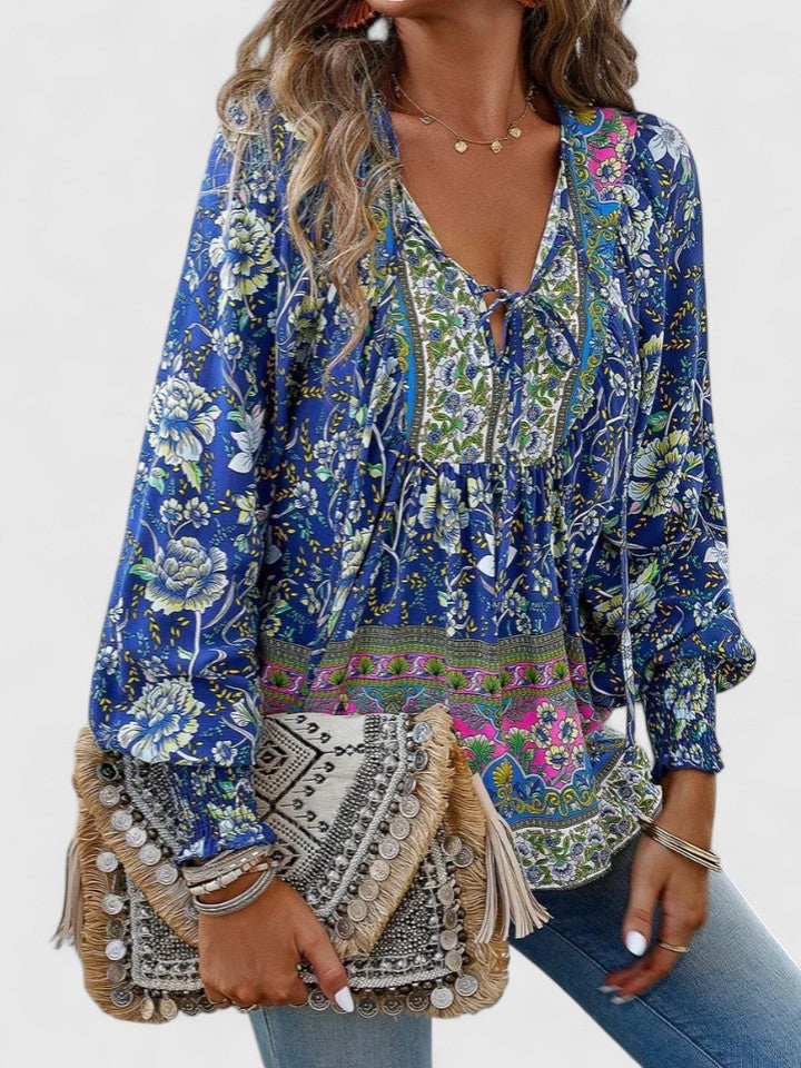 Women’s peasant top with floral print, long sleeves, and relaxed fit, suitable for casual outings, vacations, and everyday styling.