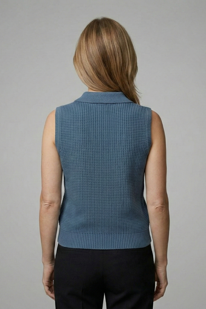 Women’s sleeveless polo top with button placket, wide shoulders, and textured finish, suitable for office wear and casual outfits.