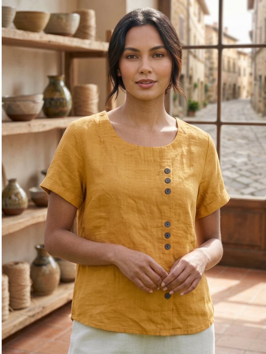 Women’s round neck blouse with button detailing and a relaxed fit, suitable for summer outfits, casual wear, and everyday styling.