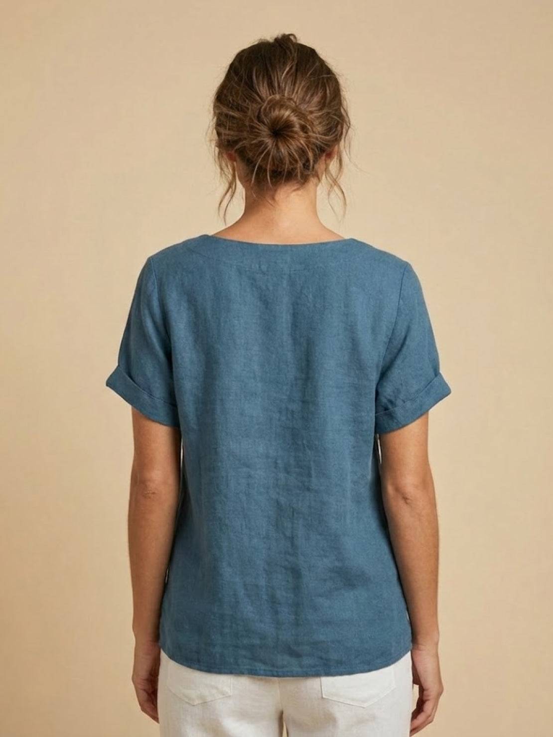 Women’s round neck blouse with button detailing and a relaxed fit, suitable for summer outfits, casual wear, and everyday styling.