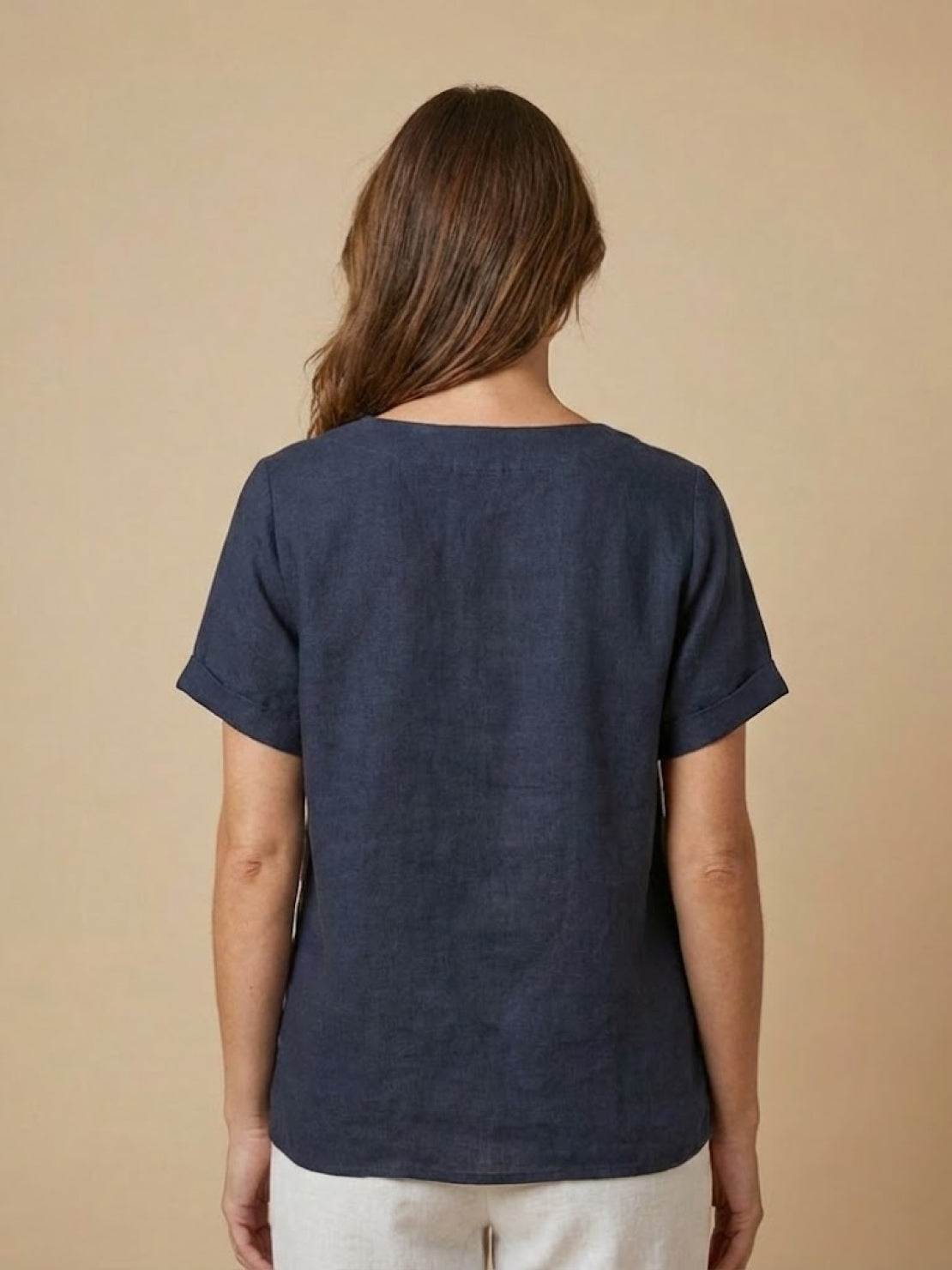Women’s round neck blouse with button detailing and a relaxed fit, suitable for summer outfits, casual wear, and everyday styling.