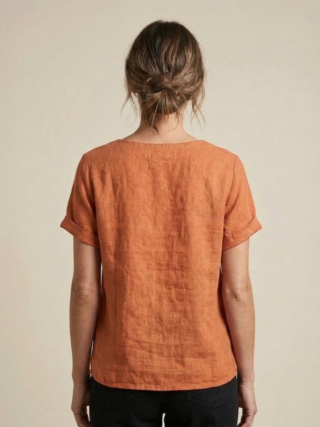 Women’s round neck blouse with button detailing and a relaxed fit, suitable for summer outfits, casual wear, and everyday styling.