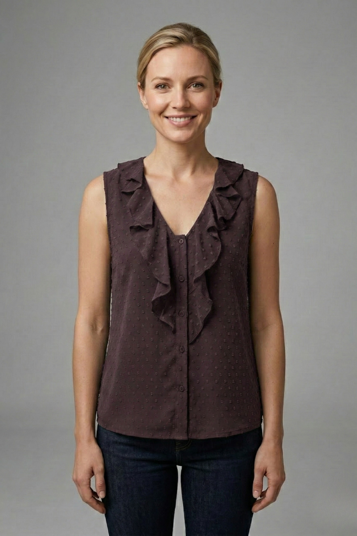 Women’s sleeveless blouse with V-neckline, ruffle trim, button detail, and textured surface, suitable for office wear and casual outfits.