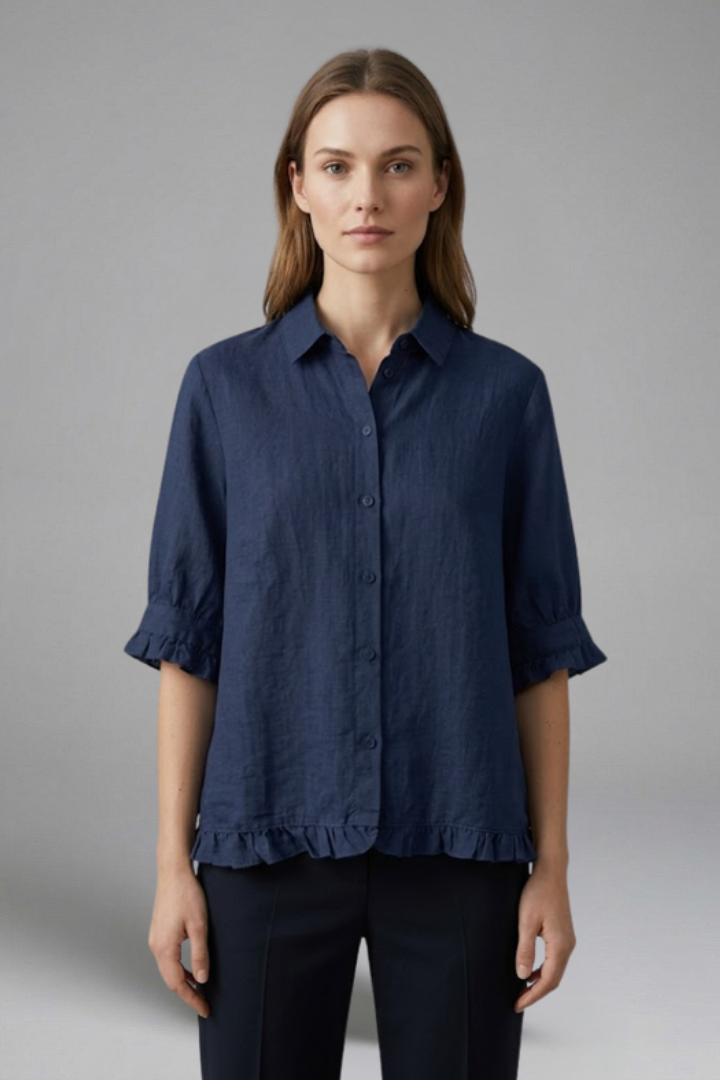 Women’s ruffle hem blouse with collared neckline, button front, and short sleeves, ideal for smart casual outfits and everyday styling.