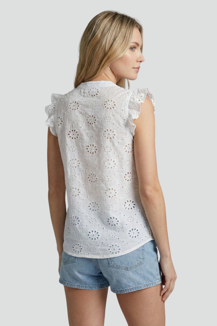 Women’s sleeveless blouse with V-neckline, ruffle shoulders, textured cut-out pattern, and straight hem for summer styling.