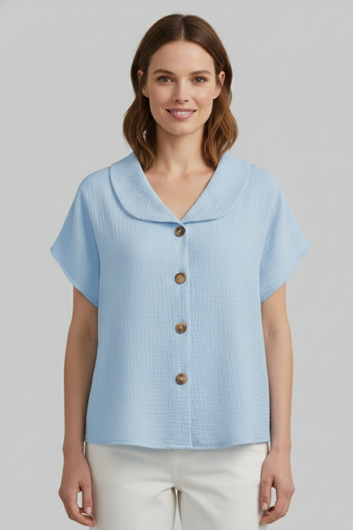 Women’s short sleeve top with V-neckline, front button detail, and textured surface, suitable for casual wear and everyday styling.