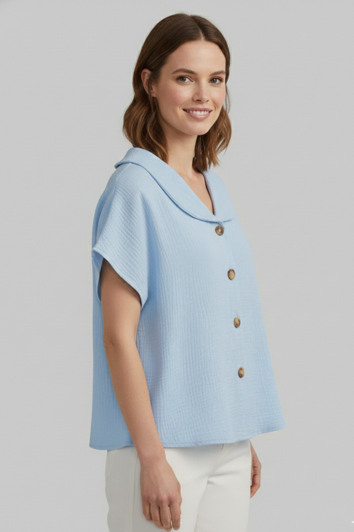 Women’s short sleeve top with V-neckline, front button detail, and textured surface, suitable for casual wear and everyday styling.