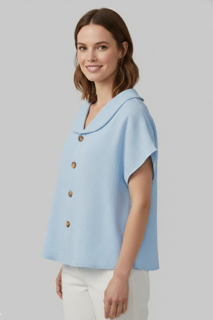 Women’s short sleeve top with V-neckline, front button detail, and textured surface, suitable for casual wear and everyday styling.