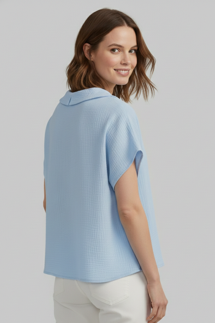Women’s short sleeve top with V-neckline, front button detail, and textured surface, suitable for casual wear and everyday styling.