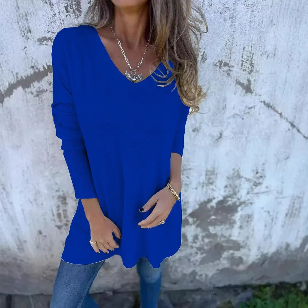 Women’s tunic top with V-neckline, longline length, and relaxed oversized fit, suitable for casual wear, layering, and everyday styling.