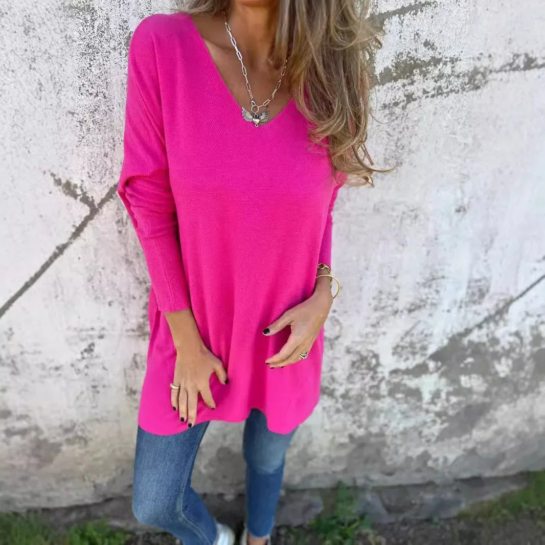 Women’s tunic top with V-neckline, longline length, and relaxed oversized fit, suitable for casual wear, layering, and everyday styling.