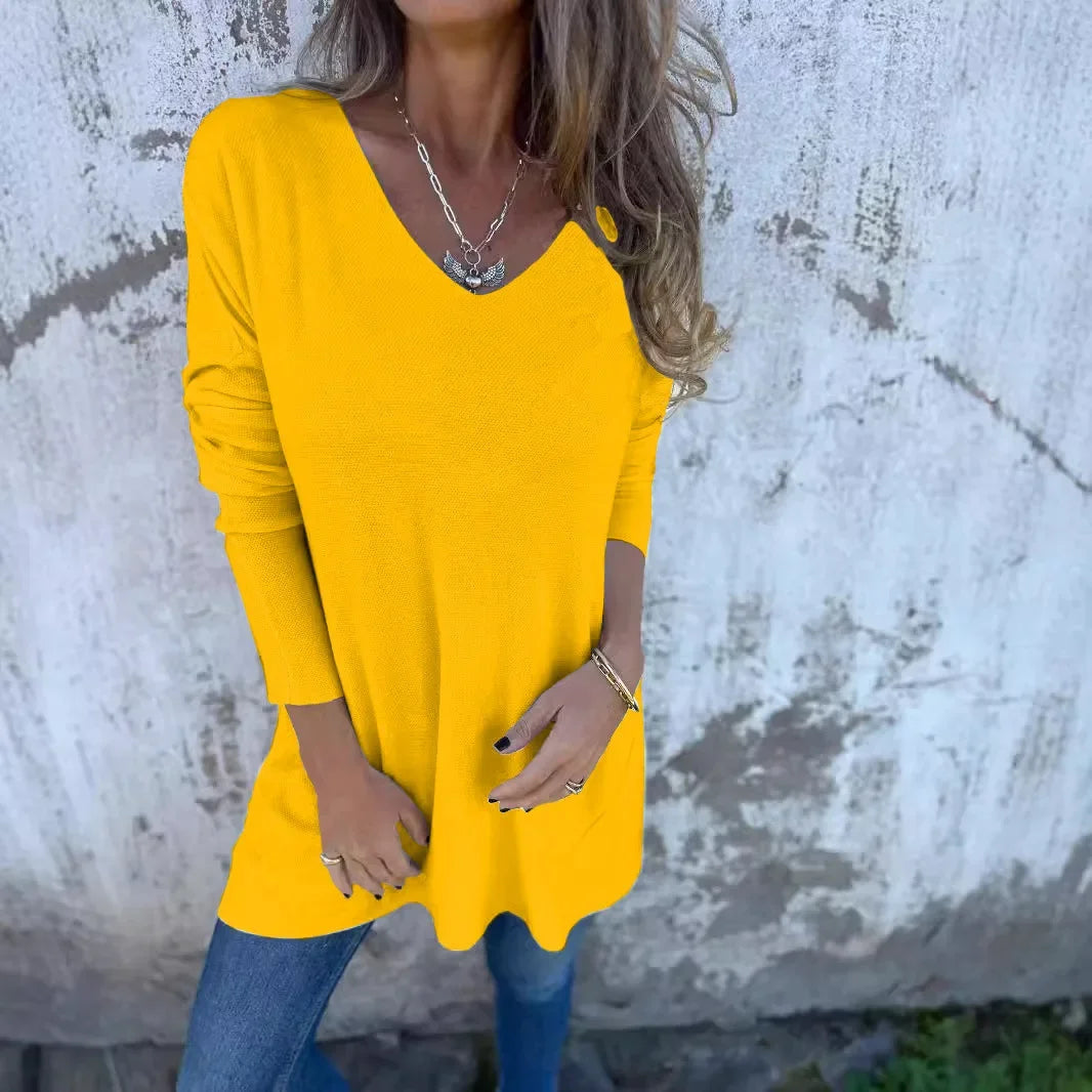 Women’s tunic top with V-neckline, longline length, and relaxed oversized fit, suitable for casual wear, layering, and everyday styling.