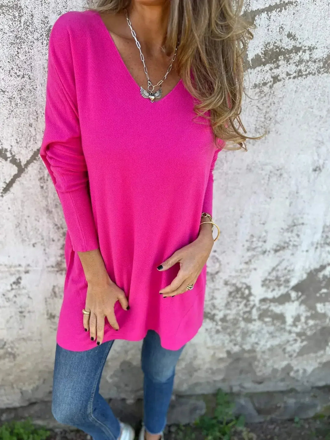 Women’s tunic top with V-neckline, longline length, and relaxed oversized fit, suitable for casual wear, layering, and everyday styling.