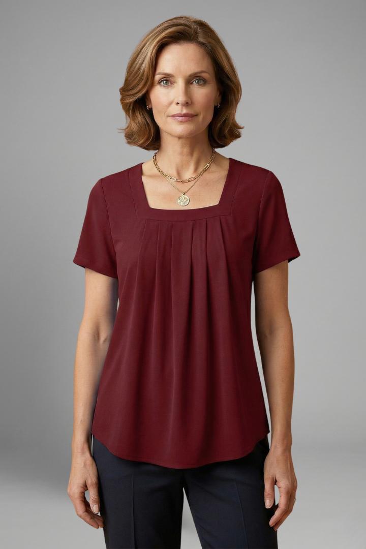 Women’s tunic top with square neckline, pleated front detail, loose fit, and hip-length hem for casual everyday styling.